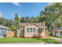 Inviting exterior of a charming house with a lush lawn at 1621 E Amelia St, Orlando, FL 32803