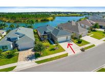 Aerial view of house near lake in quiet community at 8664 Bridgeport Bay Cir, Mount Dora, FL 32757