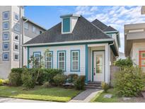 Charming cottage style home with teal accents at 14165 Moniz Ave, Orlando, FL 32827