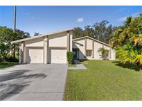 Ranch style home with two-car garage and mature landscaping at 39 Chip Ct, Kissimmee, FL 34759