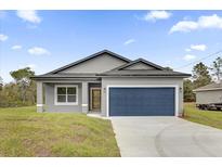 New construction home with gray exterior and blue garage door at 5 Fisher Loop Pass, Ocklawaha, FL 32179