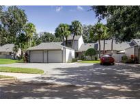 Two-story house with a two-car garage and a landscaped yard at 543 Warrenton Rd # 543, Winter Park, FL 32792