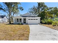 A charming craftsman style home with a white exterior and attached two-car garage at 4190 Rossmore Dr, Orlando, FL 32810