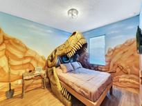 Dinosaur themed bedroom with T-Rex bed at 1465 Belle Terre Rd, Davenport, FL 33896