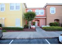 Two-story townhome with yellow and peach exterior at 904 Park Terrace Cir, Kissimmee, FL 34746