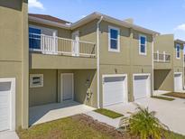Modern townhouse with attached garage and balcony at 454 Lake Shore Pkwy, Davenport, FL 33896
