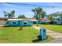 Ranch-style home with light blue siding and a well-maintained lawn at 2669 Anastasia Dr, South Daytona, FL 32119