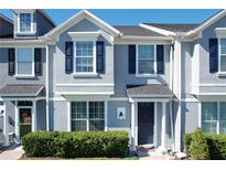 Two-story townhome with gray siding, navy shutters, and a manicured lawn at 643 Underwood Cv, Casselberry, FL 32707