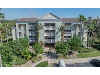 Three-story building with balconies and lush landscaping at 7659 Whisper Way # 102, Reunion, FL 34747