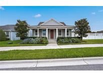 Gray craftsman style home with front porch and landscaped yard at 6275 Hamlin Reserve Blvd, Winter Garden, FL 34787