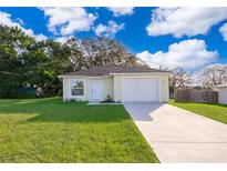 Newly constructed light yellow house with a two-car garage at 514 Margaret Ln, Lake Wales, FL 33853