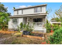 Two-story house with a front porch and garden at 2935 Aein Rd, Orlando, FL 32817