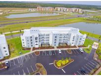 Aerial view of apartment building and parking lot at 4721 Clock Tower Dr # 207, Kissimmee, FL 34746