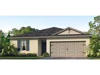 One-story home with a neutral color palette and two-car garage at 984 Bear Hammock Dr, Umatilla, FL 32784