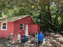Small red outbuilding with various items stored outside at 780 Snow Hill Rd, Geneva, FL 32732