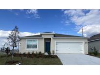 One-story house with white garage door at 959 Bear Hammock Dr, Umatilla, FL 32784