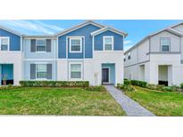 Beautiful two-story home with blue siding and landscaping at 287 Jetty Way, Davenport, FL 33897