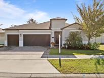 Two-story home with a two-car garage and well-maintained landscaping at 528 Bellissimo Pl, Howey In The Hills, FL 34737