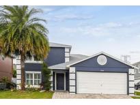 Two-story house with a two-car garage and landscaped lawn at 12914 Fair Meadows Ct, Orlando, FL 32837