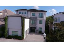 Modern three-story home with a two-car garage at 331 Muirfield Loop, Reunion, FL 34747