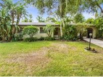 Landscaped front yard with lush tropical plants at 180 N Lakewood Cir, Maitland, FL 32751