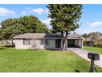 House exterior showcasing a carport and well-maintained lawn at 30 Seminole Dr, Debary, FL 32713