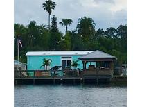 Charming waterfront home with a covered patio, perfect for enjoying the view at 1315 Pine Island N Dr, Saint Cloud, FL 34771