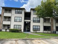 Two-story apartment building with green lawn at 4647 Cason Cove Dr # 2425, Orlando, FL 32811