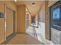 Building hallway with elevator and apartment access at 912 Charo Pkwy # 223, Davenport, FL 33897
