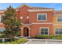 Townhouse exterior featuring attractive landscaping at 2955 Banana Palm Dr, Kissimmee, FL 34747