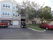 Exterior view of building with parking and golf cart at 3280 Soho St # 102, Orlando, FL 32835