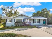 Light gray single-story house with a landscaped yard and driveway at 504 Osceola Ave, Eustis, FL 32726