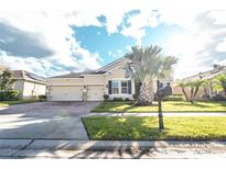 Two-story home with a three-car garage and a landscaped yard at 1511 Alligator St, St Cloud, FL 34771
