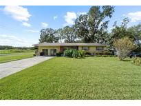 Single-story home with a brick facade and a spacious lawn at 1004 Wildwood E, Lakeland, FL 33801