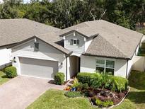 Aerial view of a two-story house with landscaped yard at 737 Daybreak Pl, Longwood, FL 32750