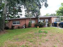 Front view of ranch house with landscaping and driveway at 222 Ronnie Cir, Orlando, FL 32811