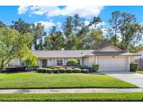 House exterior showcasing a well-maintained lawn and landscaping at 734 Riverbend Blvd, Longwood, FL 32779