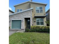 Modern two-story house with green door and stone accents at 2813 Bookmark Dr, Kissimmee, FL 34746