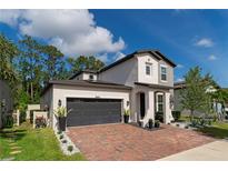 Two-story home with a dark gray garage door at 5443 Carrara Ct, St Cloud, FL 34771