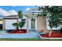 Charming one-story house with a brick facade and well-manicured lawn at 125 Grand Junction Blvd, Orlando, FL 32835