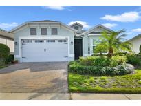 Single-story home with two-car garage and landscaping at 2160 Antilles Club Dr, Kissimmee, FL 34747