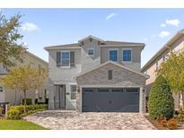 Beautiful two-story home with stone accents and a large driveway at 365 Southfield St, Kissimmee, FL 34747