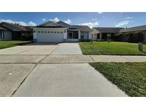 House exterior showing a one-story home with a two-car garage and well-maintained lawn at 4612 Cheyenne Point Trl, Kissimmee, FL 34746