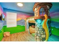 bedroom with a fairytale-themed bunk bed and mural at 1430 Thunderbird Rd, Davenport, FL 33896