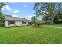 House exterior with a lush green lawn and mature trees at 2315 Weber St, Orlando, FL 32803