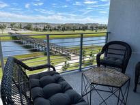 Relaxing balcony overlooking a lake and community at 3161 Paradox Cir # 301, Kissimmee, FL 34746