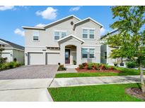 Two story home with two car garage and landscaped yard at 11648 Paragraph Rd, Orlando, FL 32832
