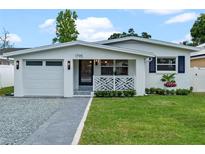 Charming single story home with a modern white exterior and landscaped lawn at 1795 Walker Ave, Winter Park, FL 32789