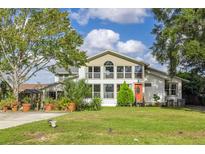 Two-story home with a large front yard and landscaping at 4801 Beach Blvd, Orlando, FL 32803