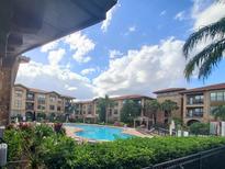 View of the resort-style pool and surrounding buildings at 910 Charo Pkwy # 332, Davenport, FL 33897